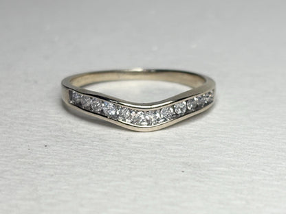 Contoured 14k white gold wedding band with channel-set diamonds.
