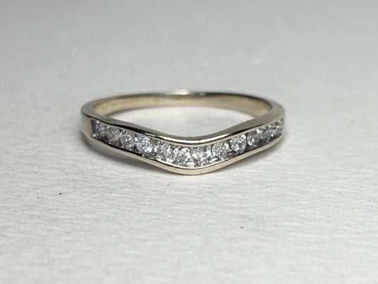 Contoured 14k white gold wedding band with channel-set diamonds.
