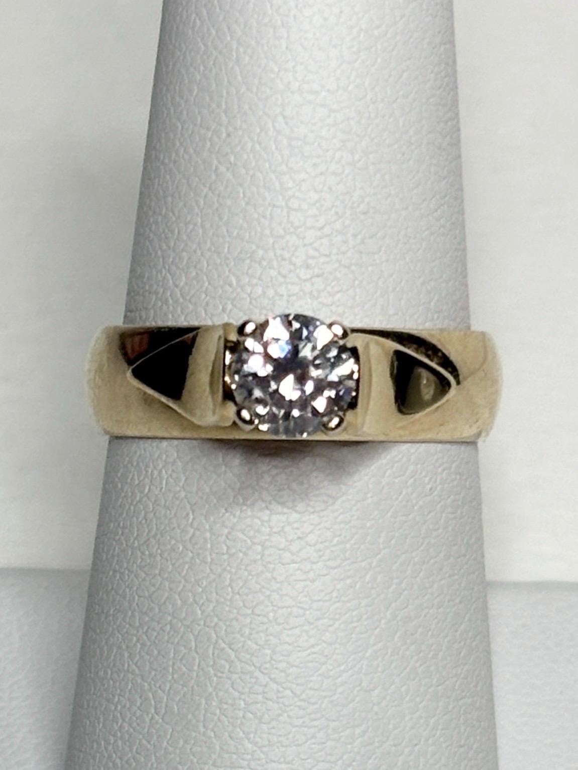 A vintage 14k gold band ring with a .75ct solitaire diamond.