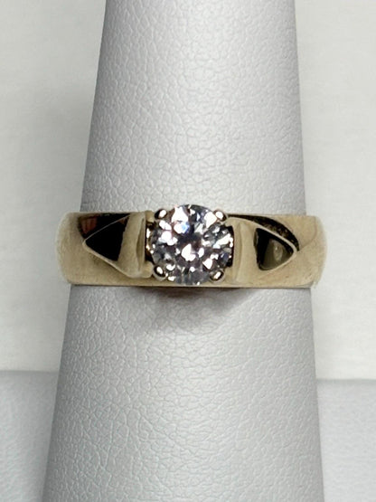A vintage 14k gold band ring with a .75ct solitaire diamond.