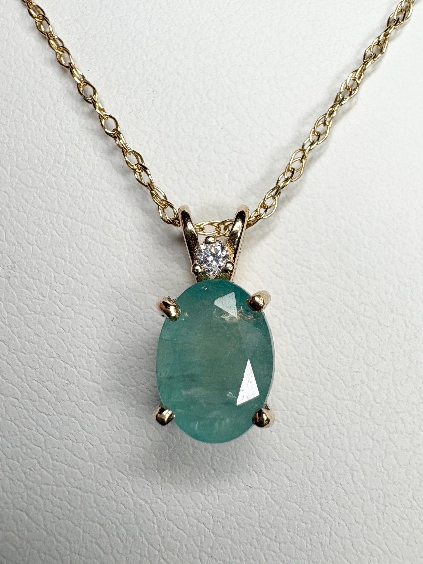 14k gold necklace with oval grandidierite and diamond pendant.