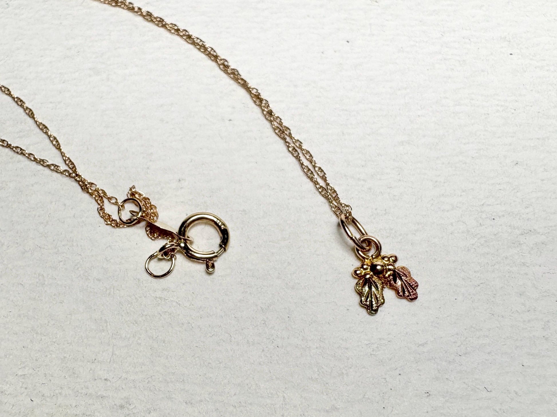 Dainty 10k gold Black Hills Gold pendant necklace with a spring ring clasp.