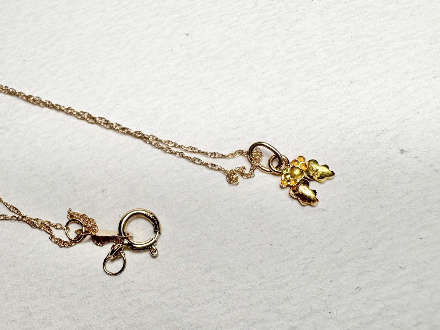 Dainty 10k gold necklace with a Black Hills Gold pendant and spring ring clasp.