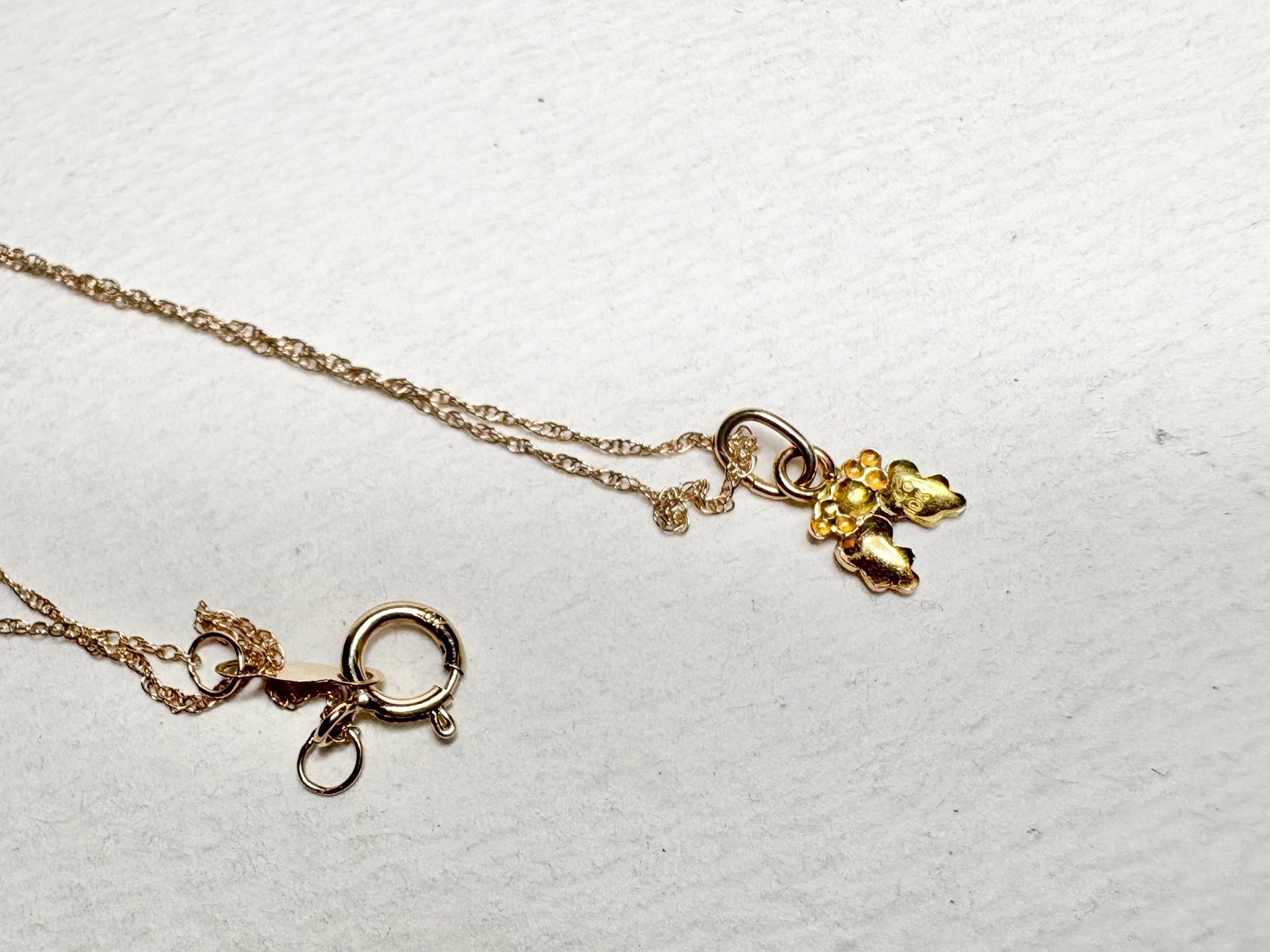 Dainty 10k gold necklace with a Black Hills Gold pendant and spring ring clasp.