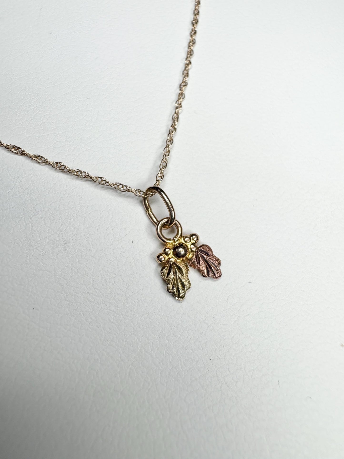 Dainty 10k gold Black Hills Gold pendant necklace with three leaves.