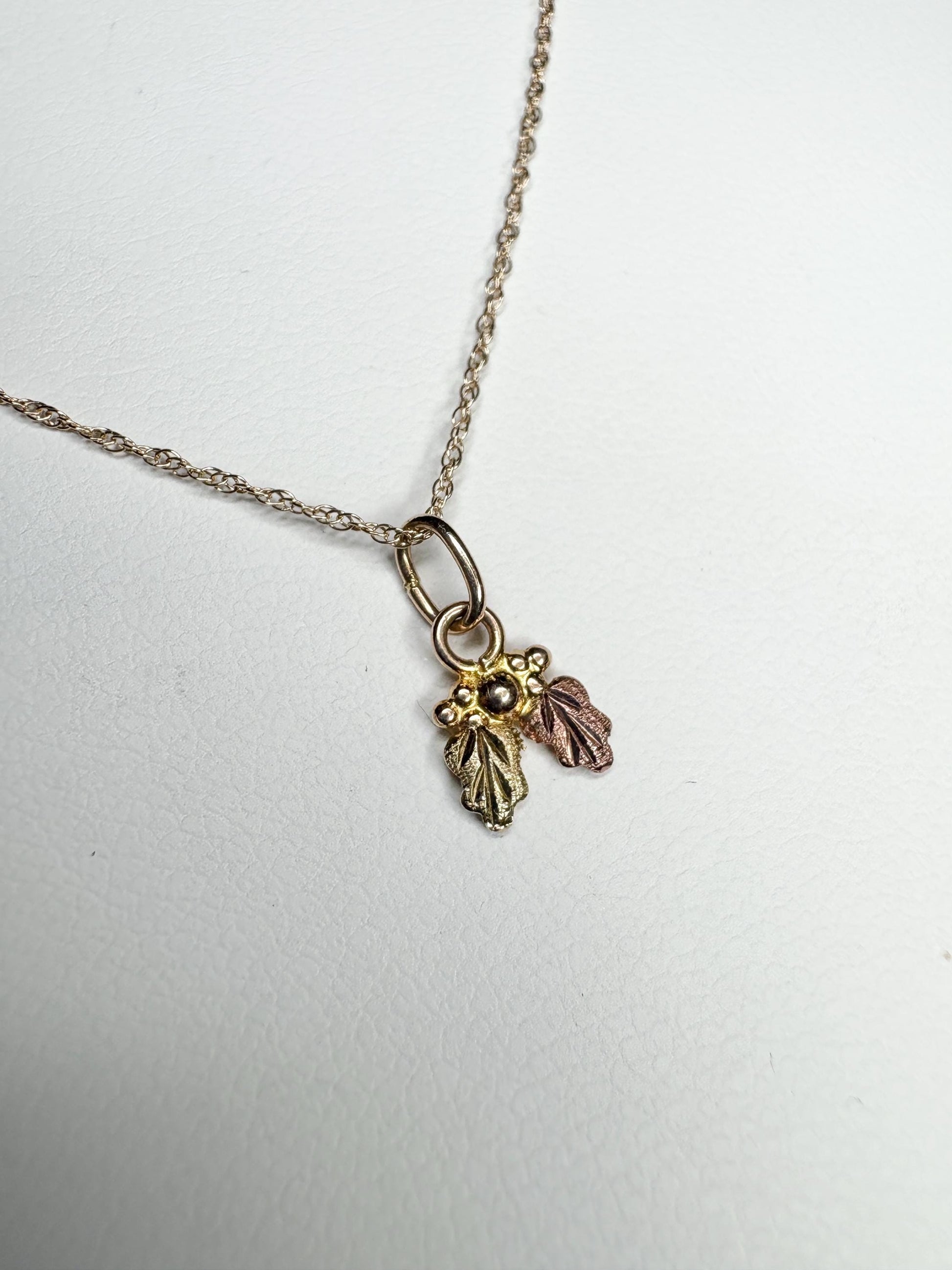 Dainty 10k gold Black Hills Gold pendant necklace with three leaves.
