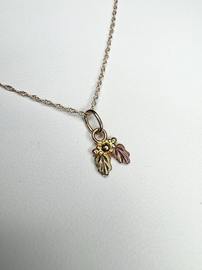 Dainty 10k gold Black Hills Gold pendant necklace with three leaves.