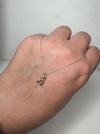 Dainty Black Hills Gold pendant necklace with leaves and berries on an 18-inch chain.