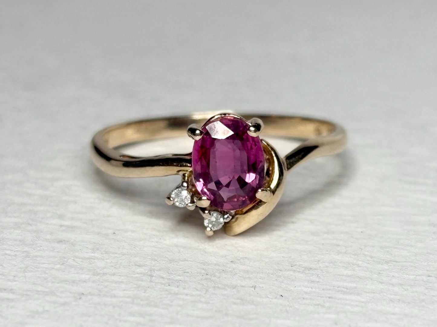 Pink sapphire and diamond ring in solid 14k gold.