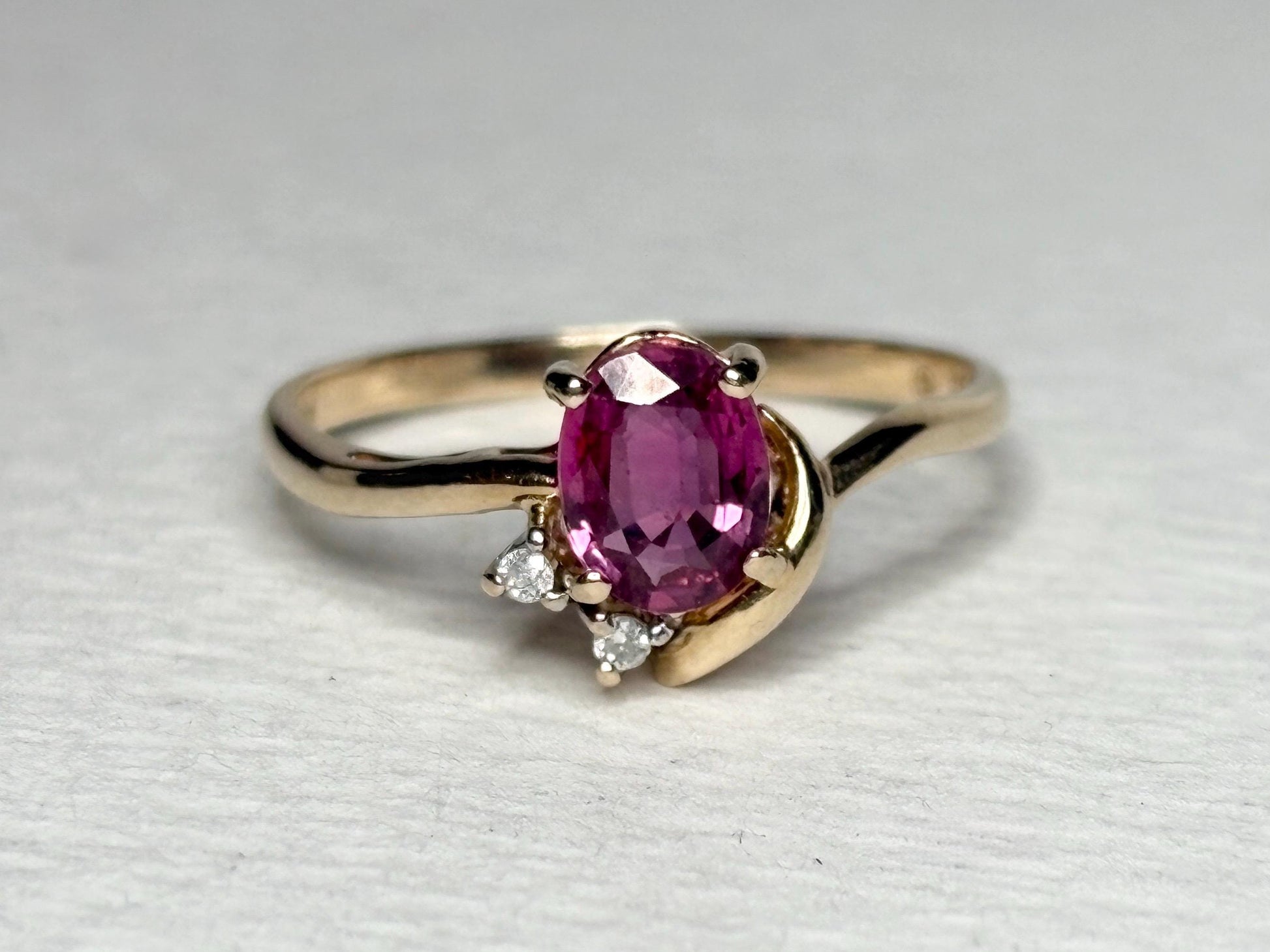 Pink sapphire and diamond ring in solid 14k gold.