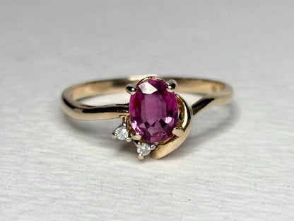 Pink sapphire and diamond ring in solid 14k gold.