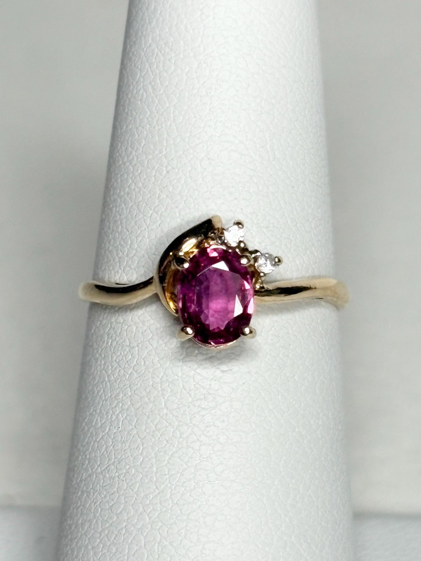 Pink sapphire and diamond ring in 14k gold.