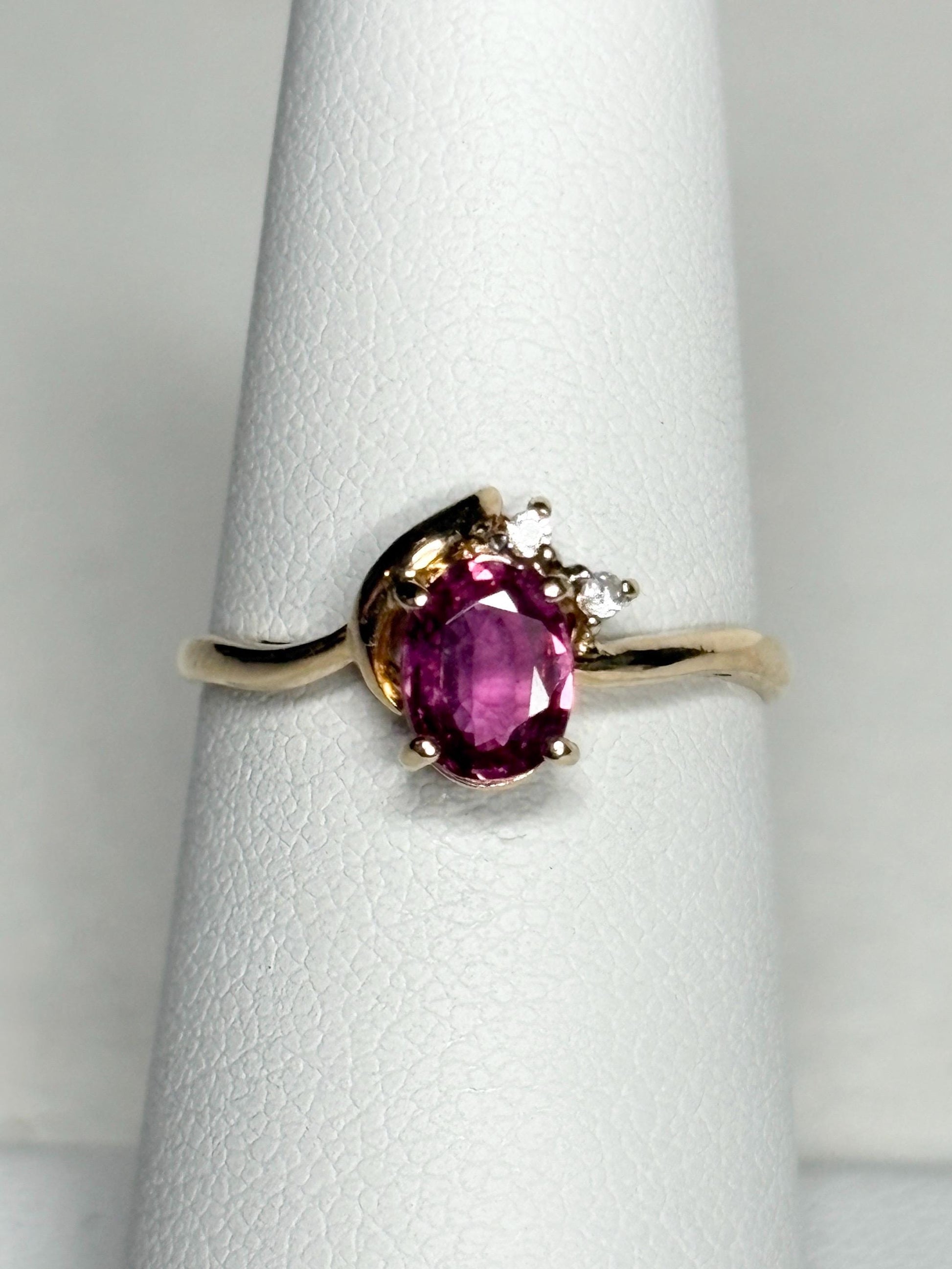 Pink sapphire and diamond ring in 14k gold.