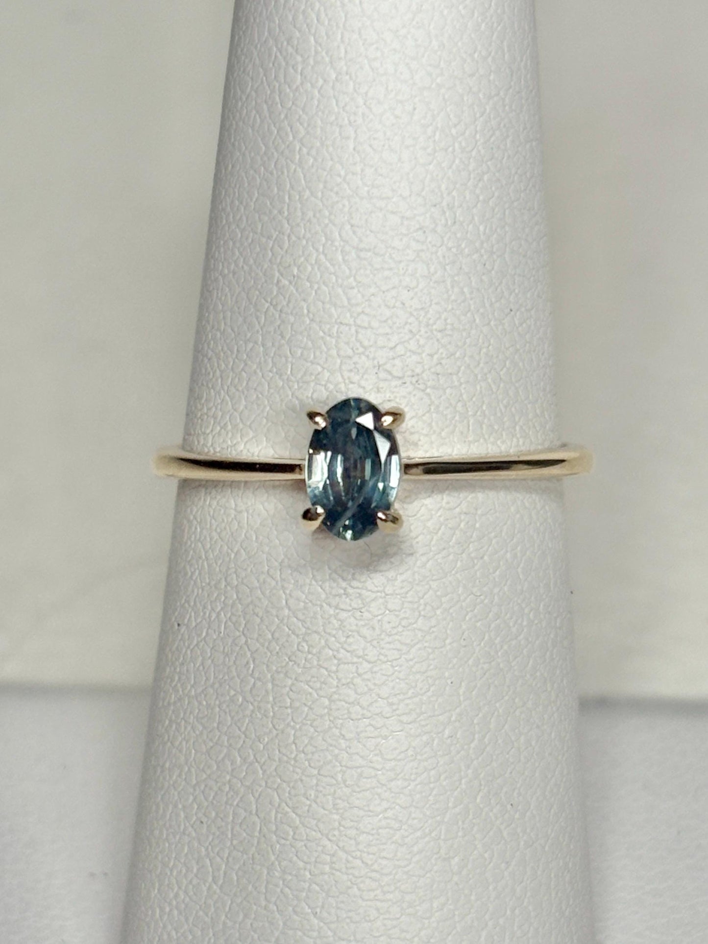 Oval Montana sapphire solitaire ring in solid 10k gold.