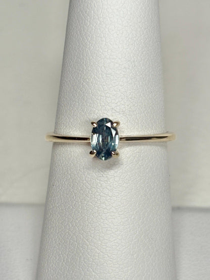 Oval Montana sapphire solitaire ring in solid 10k gold.