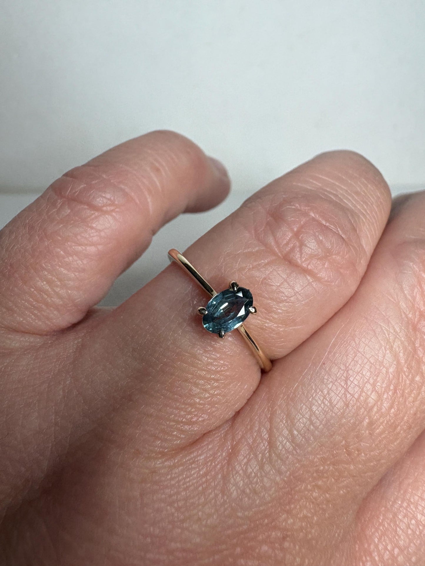 A 10k gold ring with a .56ct oval Montana sapphire.