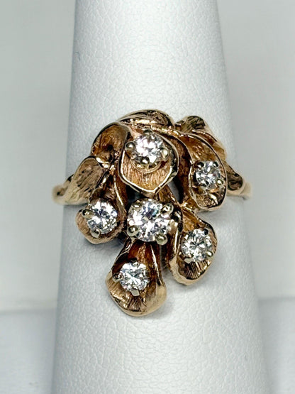 Mid Century 14k gold ring with cascading floral design and diamonds.
