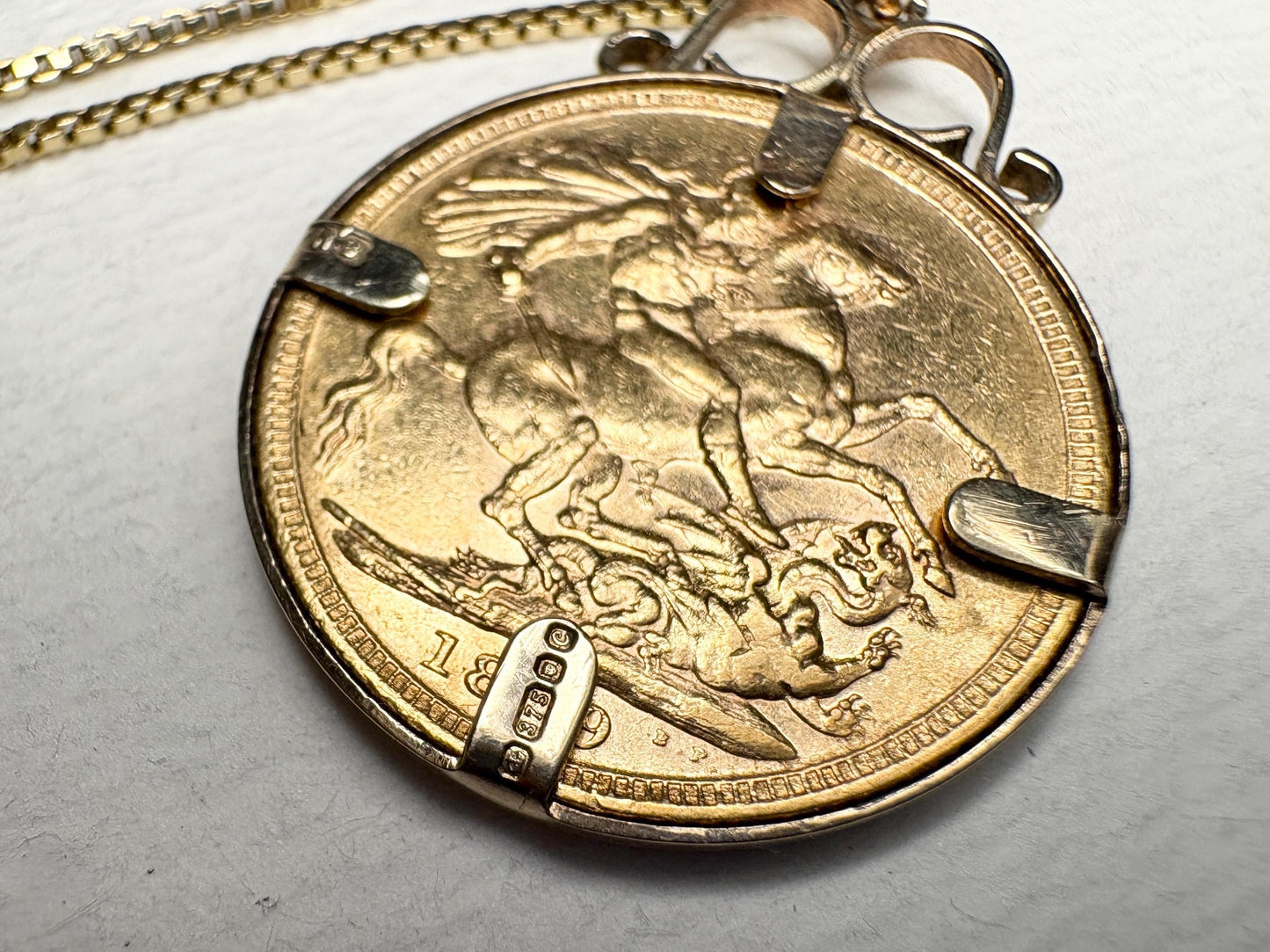 Gold coin pendant with Queen Victoria and St. George, 1899, on a gold chain.