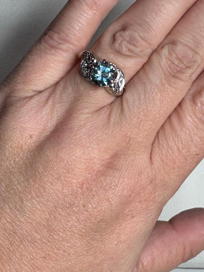 A vintage 14k white gold ring with a blue topaz and diamonds.