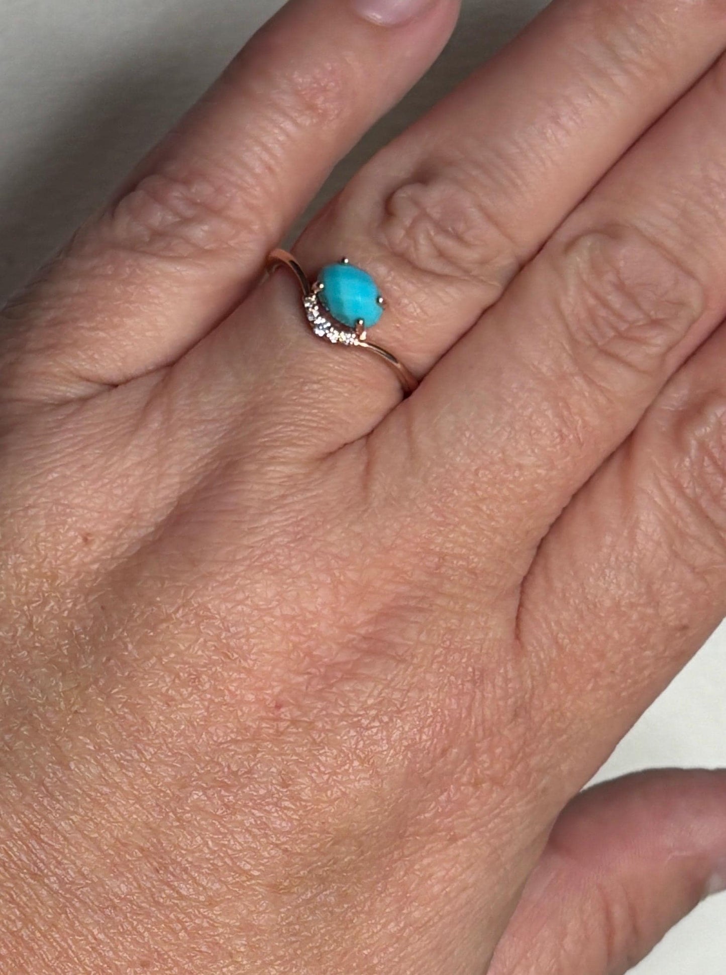 10k rose gold ring with oval checkerboard turquoise and diamonds.
