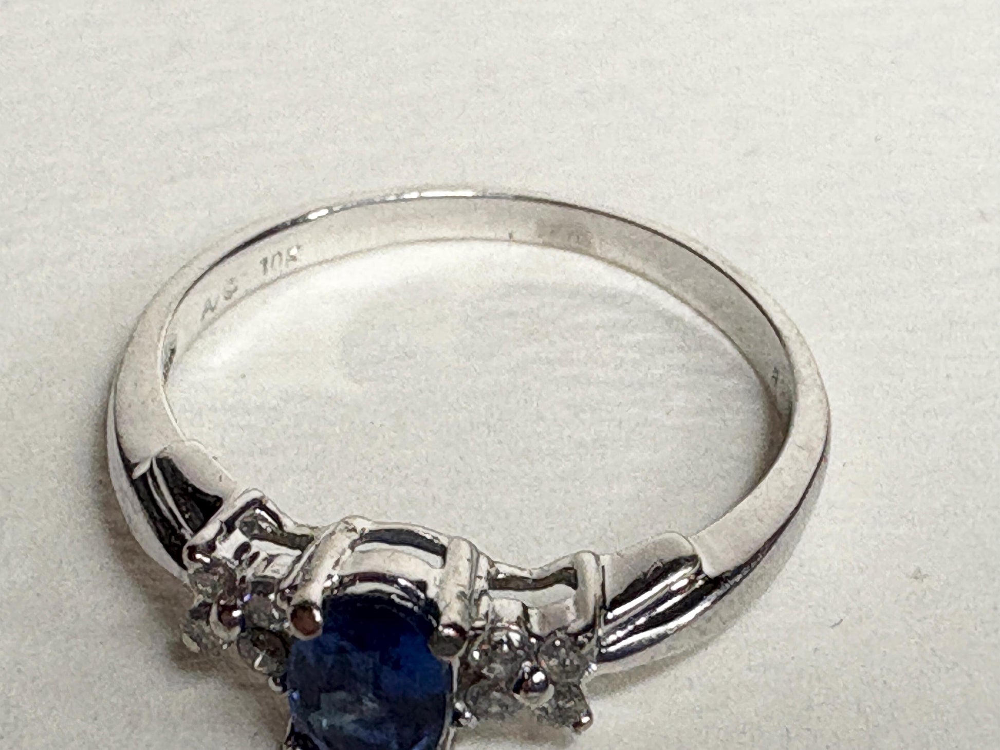 A 10k white gold ring with a blue kyanite center stone and small diamonds.