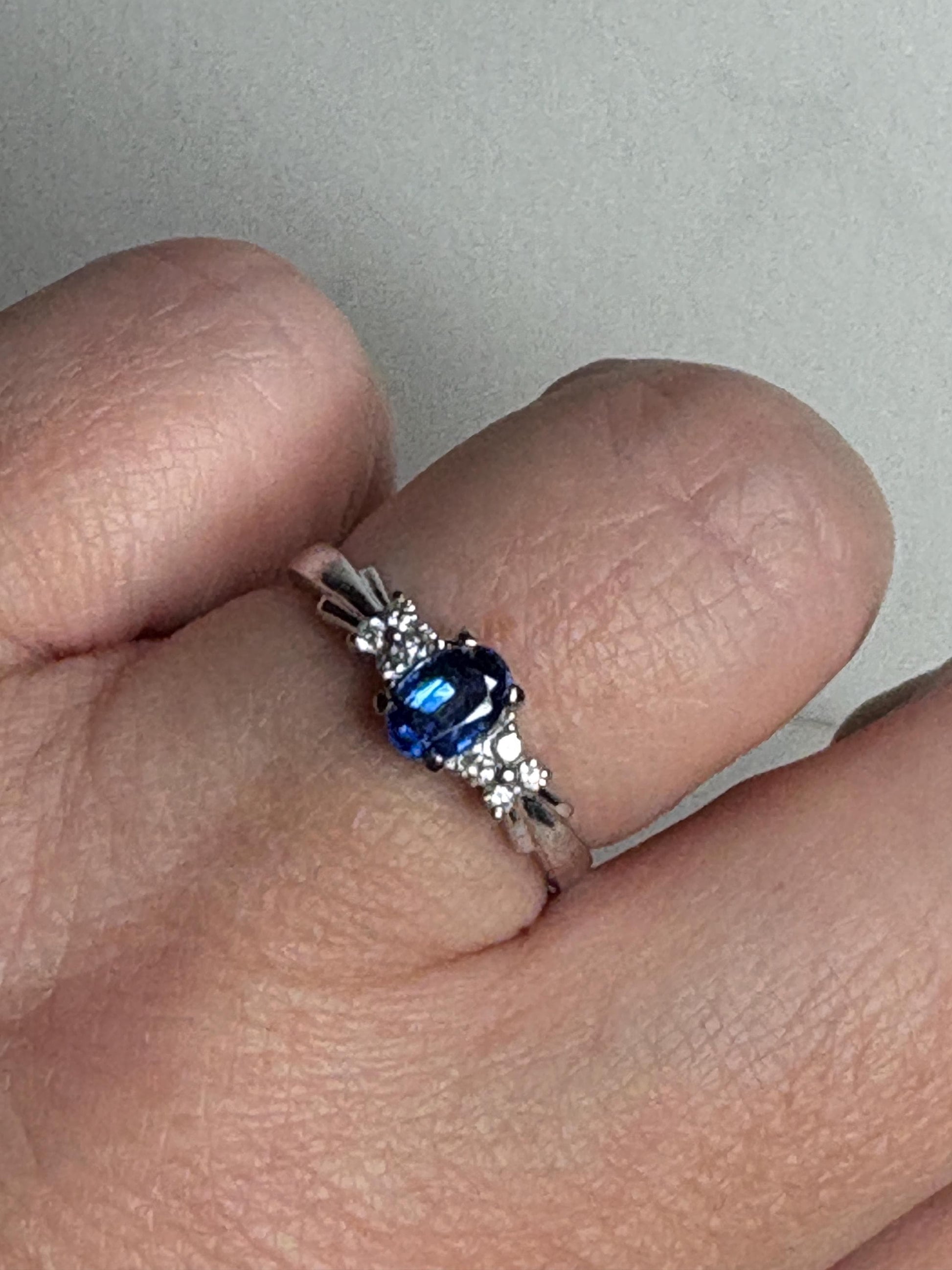 A 10k white gold ring with an oval kyanite center stone and diamond accents.