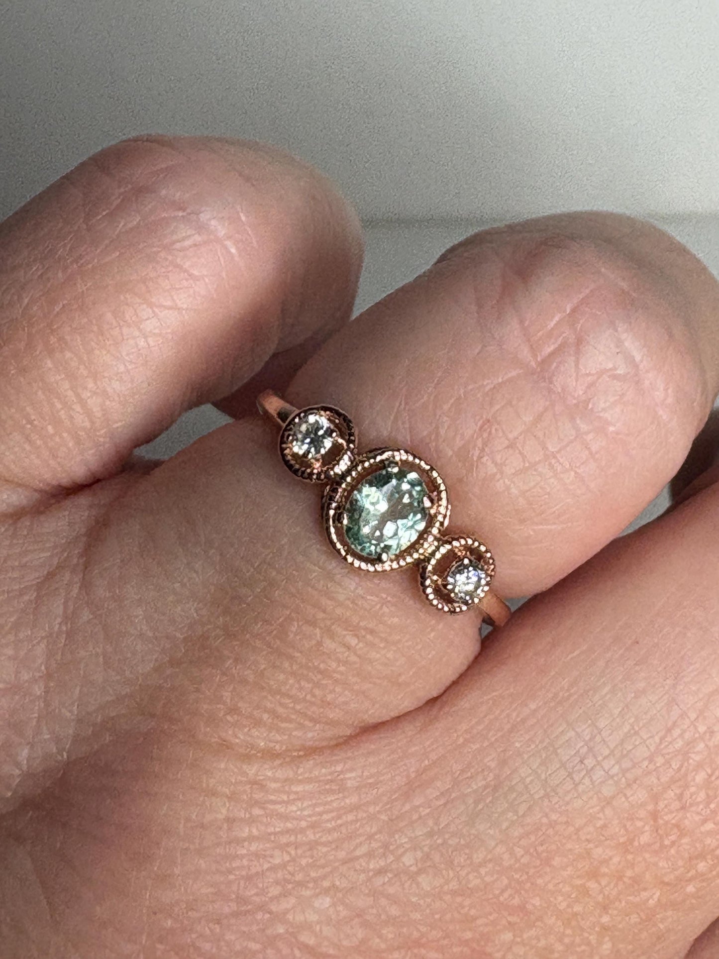 14k rose gold ring with a mint green oval tourmaline and two diamonds.