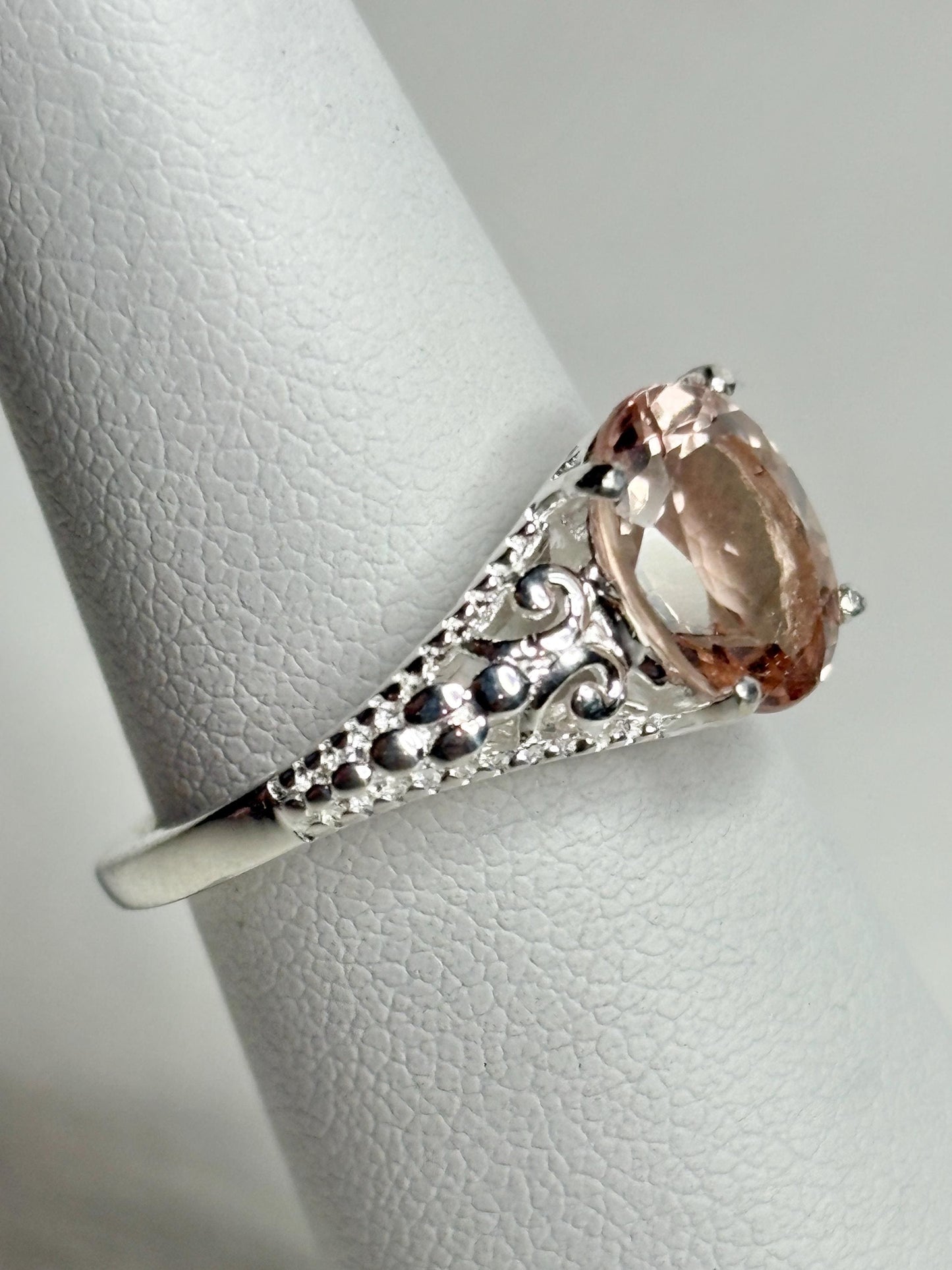 Sterling silver ring with an oval, soft pink morganite and ornate detailing.