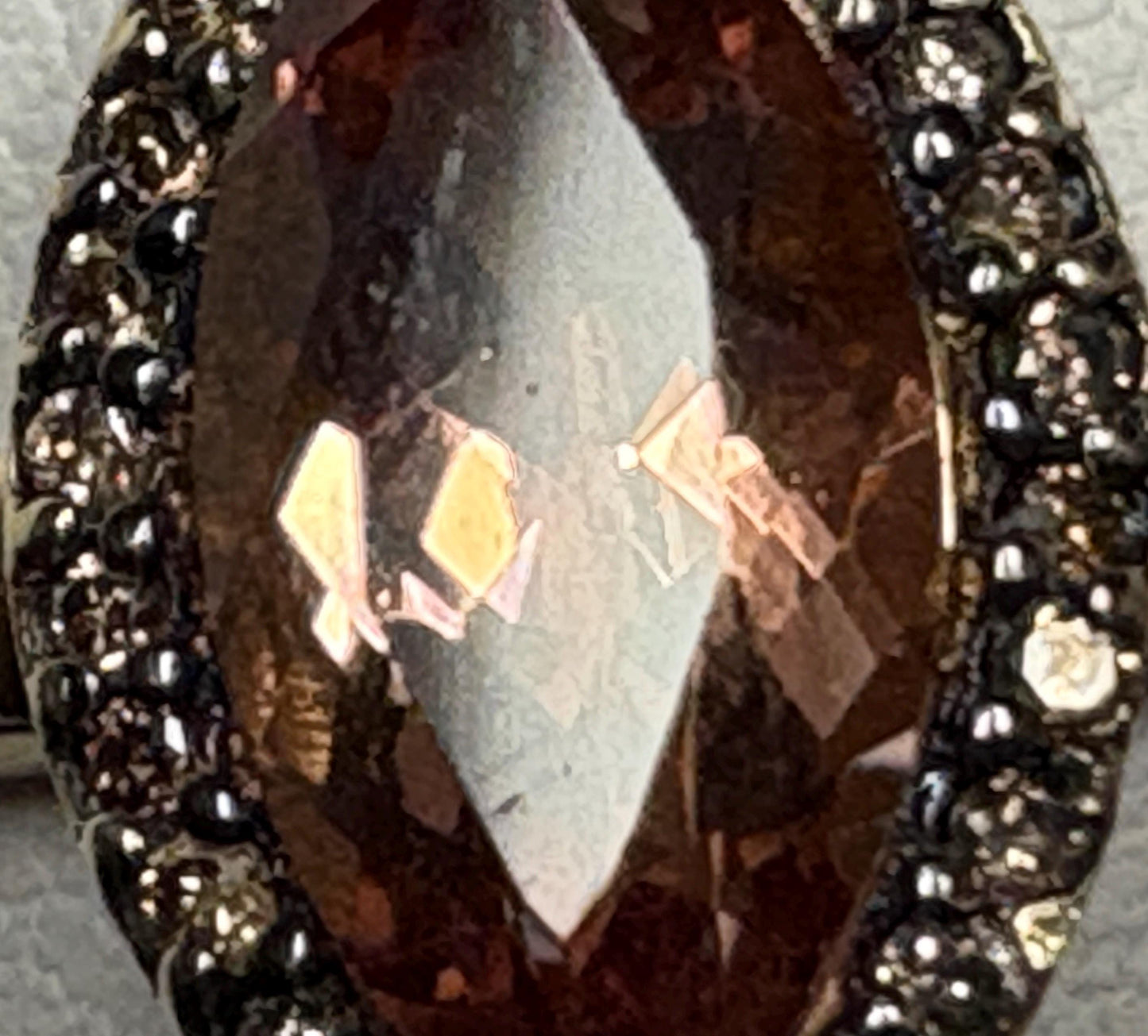 Marquise Oregon sunstone ring with champagne diamonds in 10k gold.