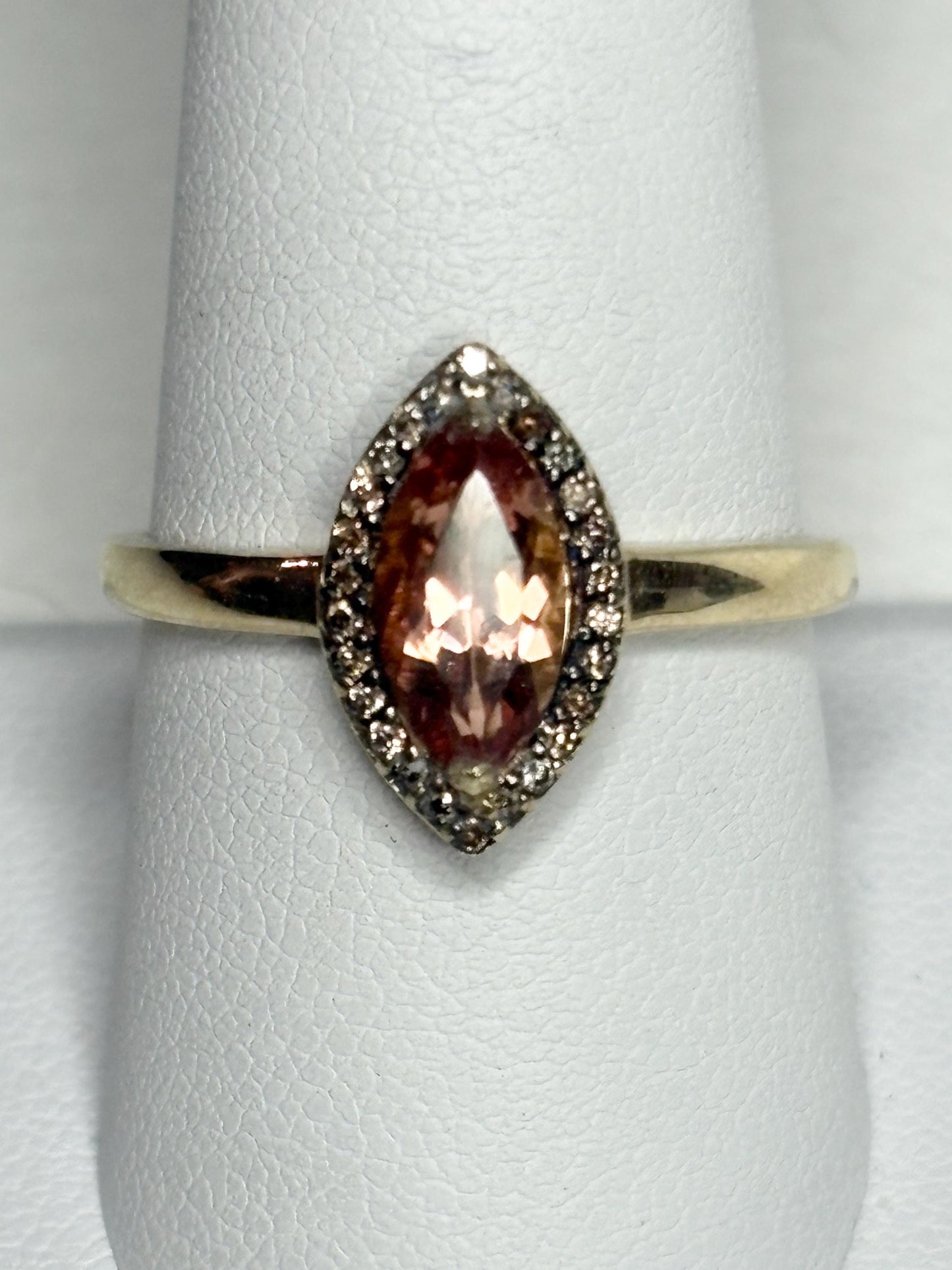 A 10k gold ring with a peach Oregon sunstone and champagne diamonds.