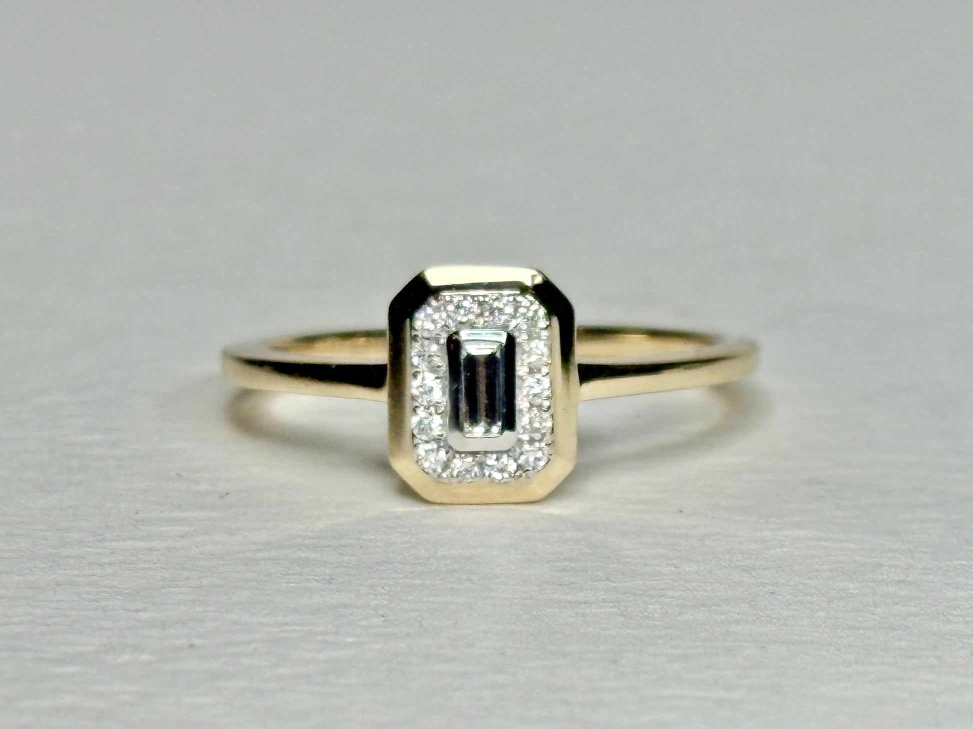 Effy 14k gold ring with a bezel-set baguette diamond surrounded by smaller diamonds.