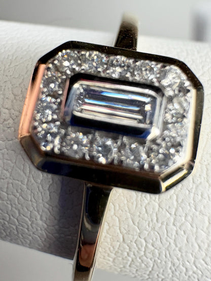 Effy 14k yellow gold ring with a bezel-set baguette diamond surrounded by a halo of smaller diamonds.