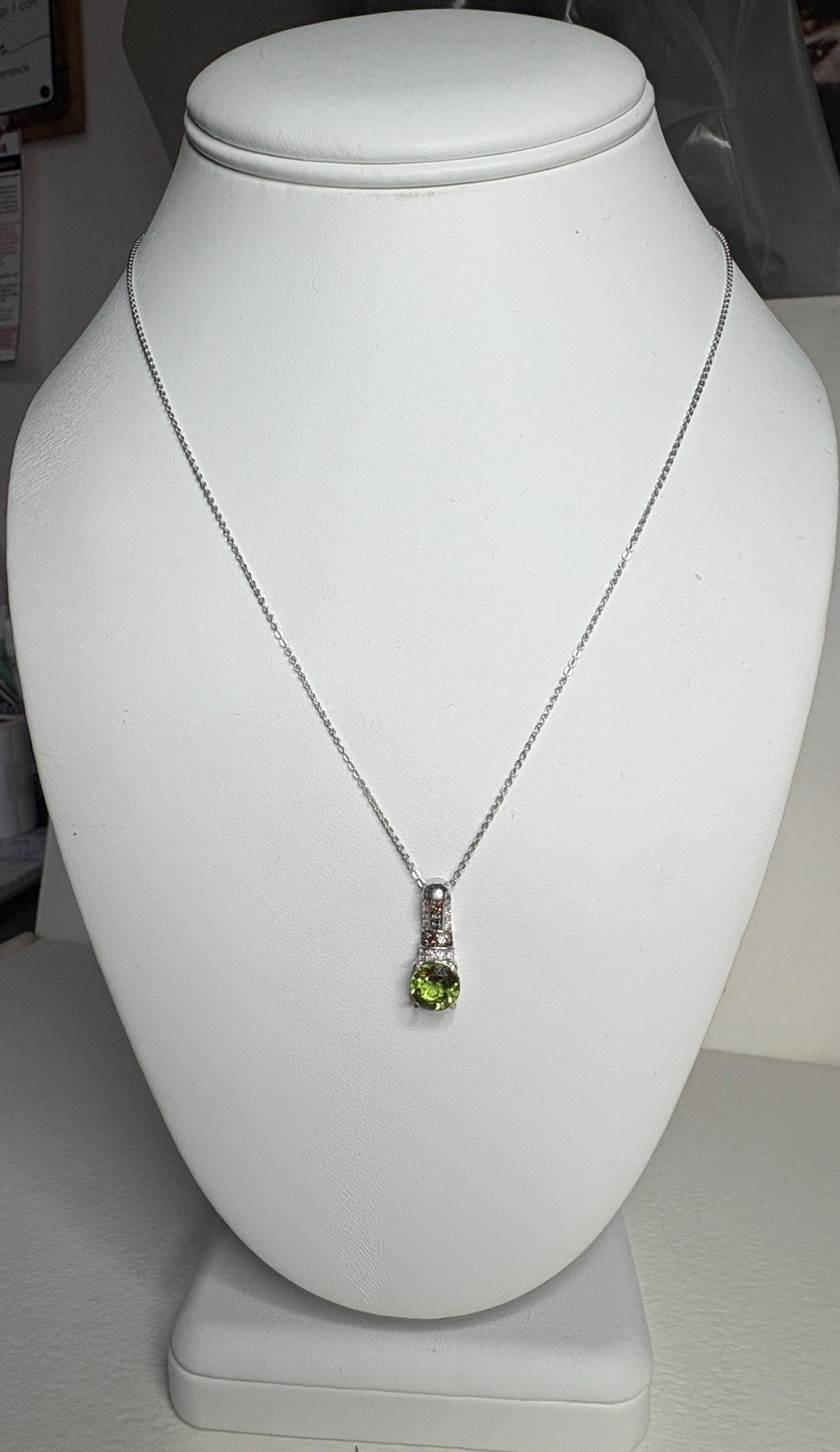 Sterling silver necklace with a simulated diaspore pendant and moissanite accents.