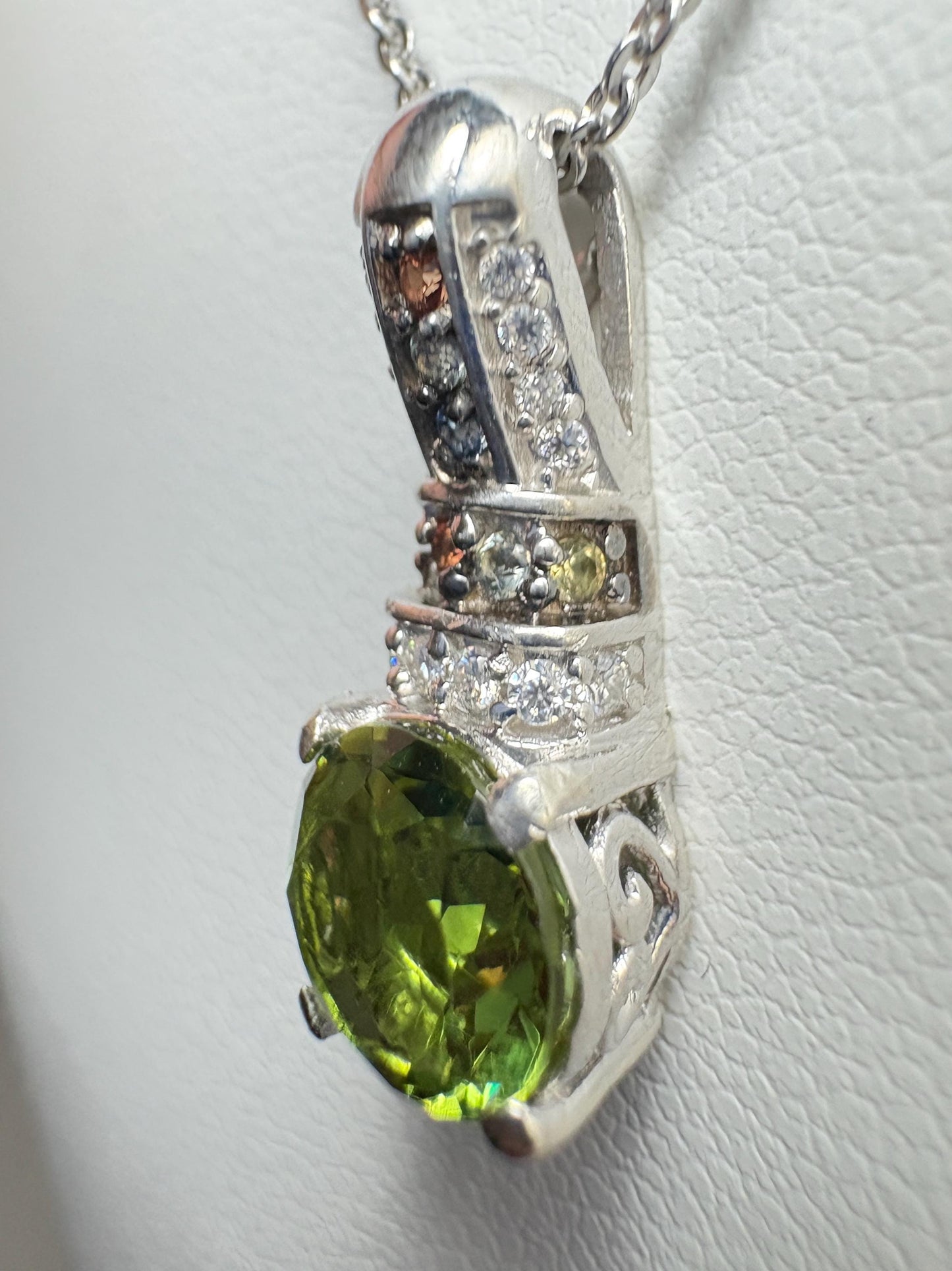 Sterling silver pendant necklace with a green simulated diaspore and colorful accent stones.