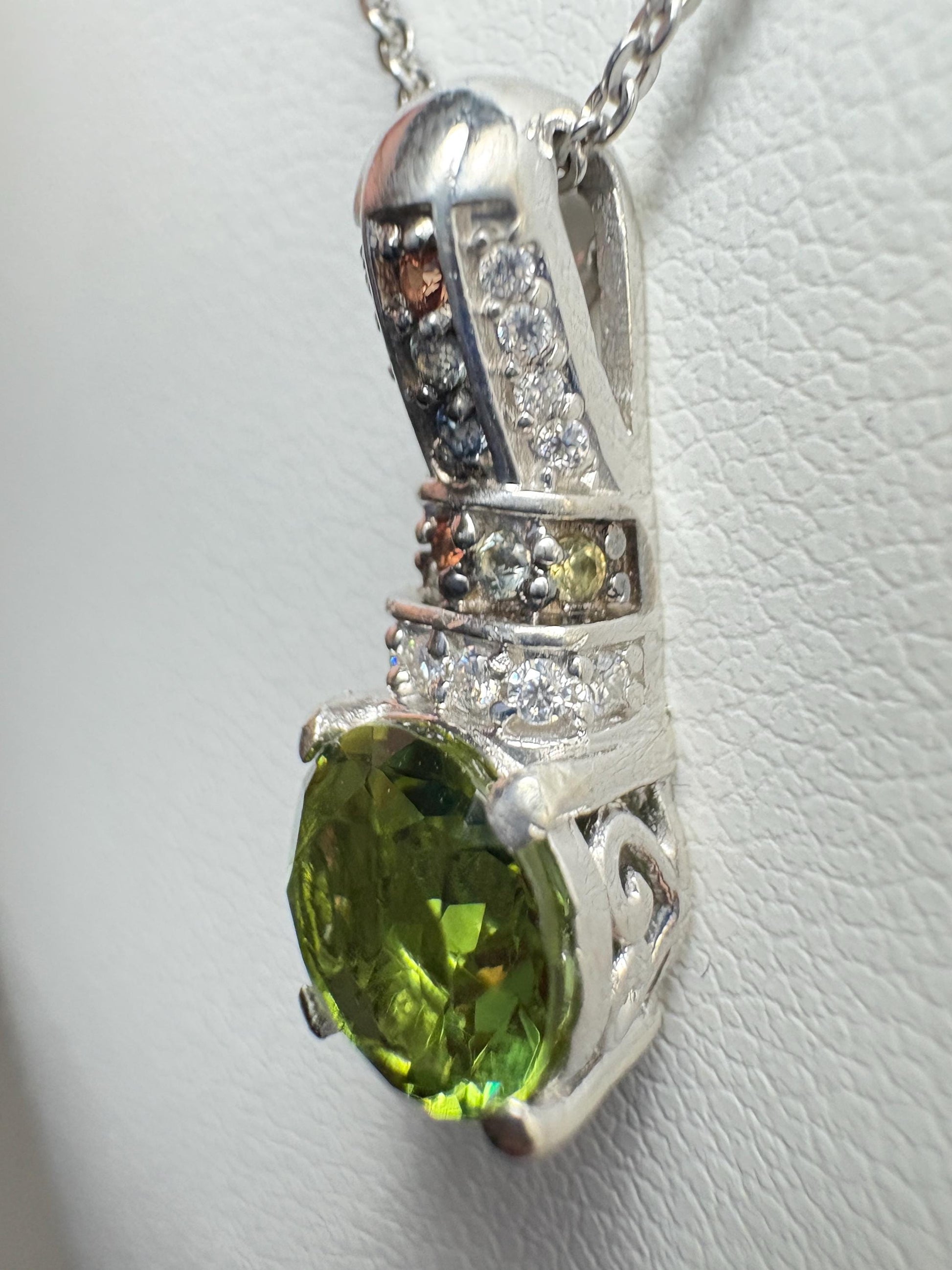 Sterling silver pendant necklace with a green simulated diaspore and colorful accent stones.