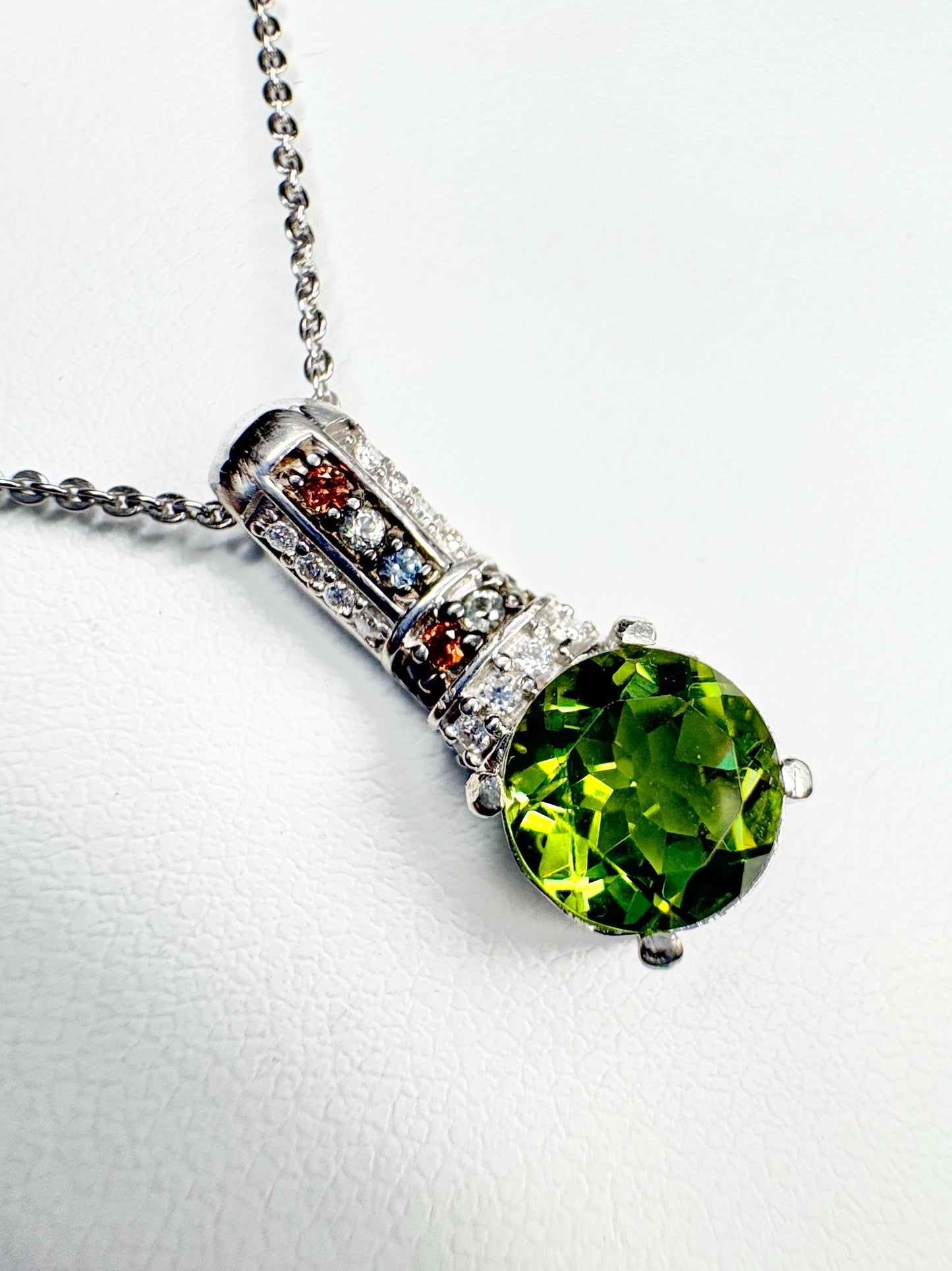 Sterling silver pendant necklace with a green simulated diaspore and colorful accent stones.