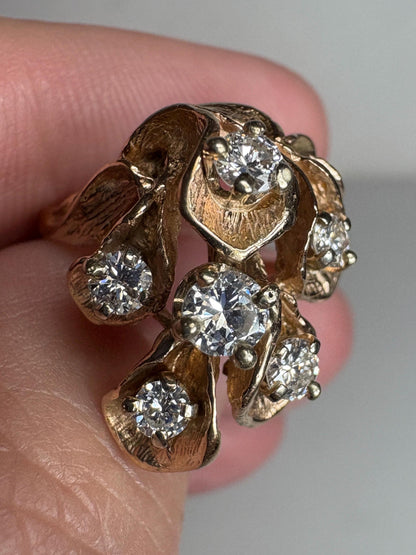 A 14k gold ring with cascading floral lilies and .75ctw diamonds.
