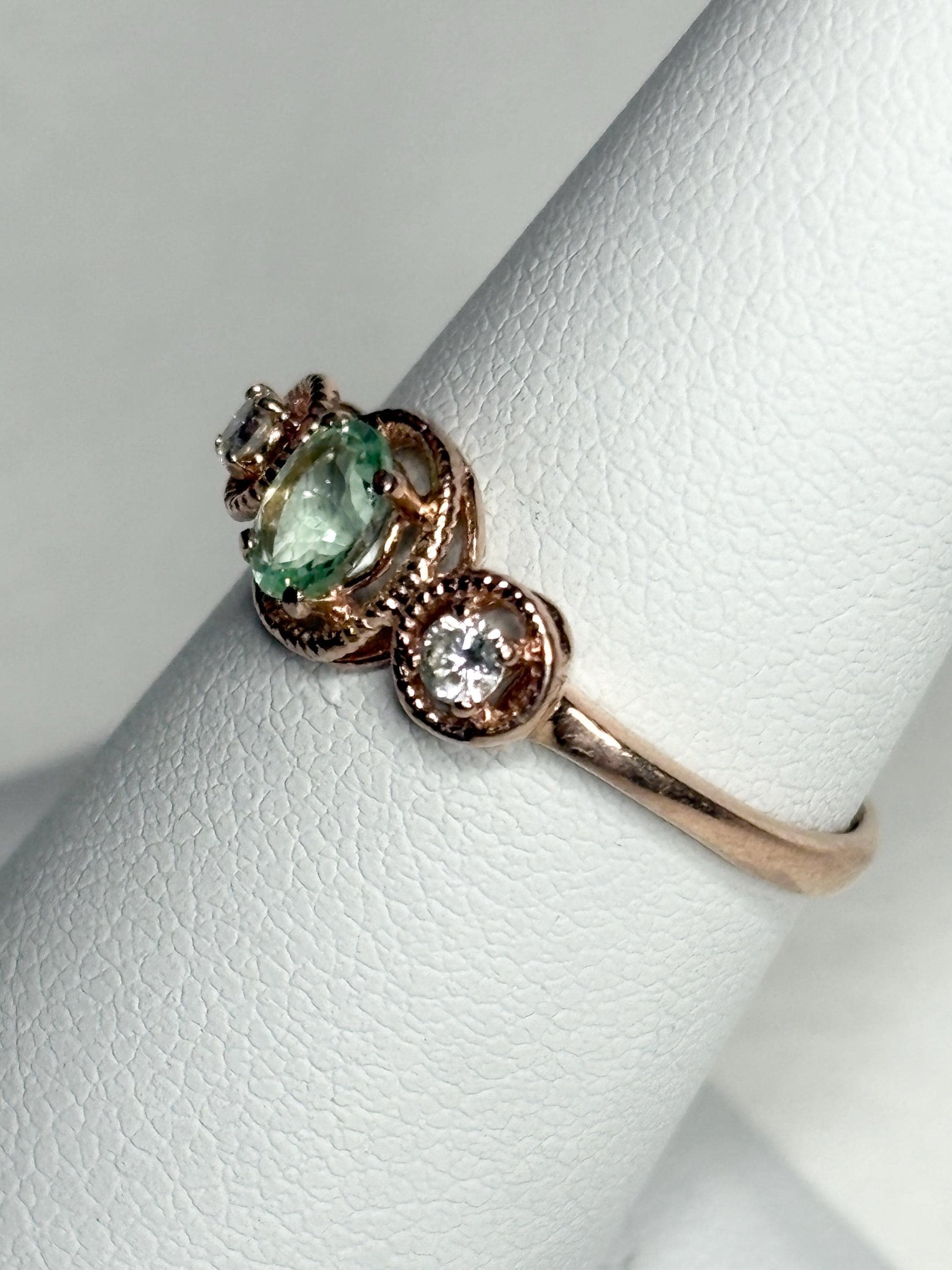 14k rose gold ring with a mint green tourmaline and two diamonds.