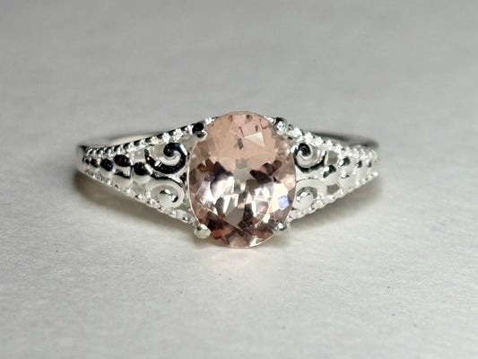 Sterling silver ring with an oval pink morganite and ornate detailing.