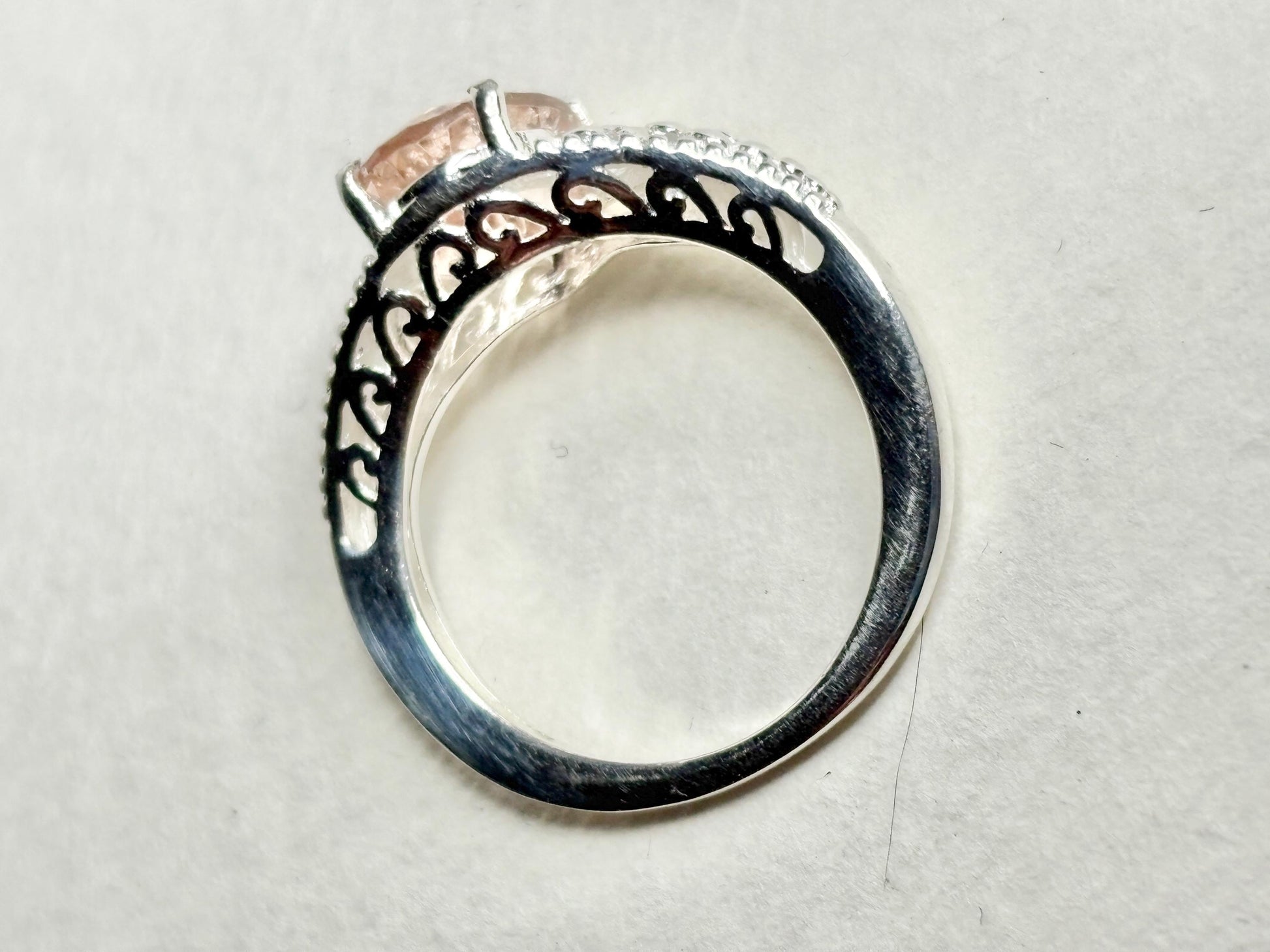 Sterling silver ring with a pink morganite and ornate detailing.