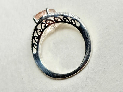Sterling silver ring with a pink morganite and ornate detailing.