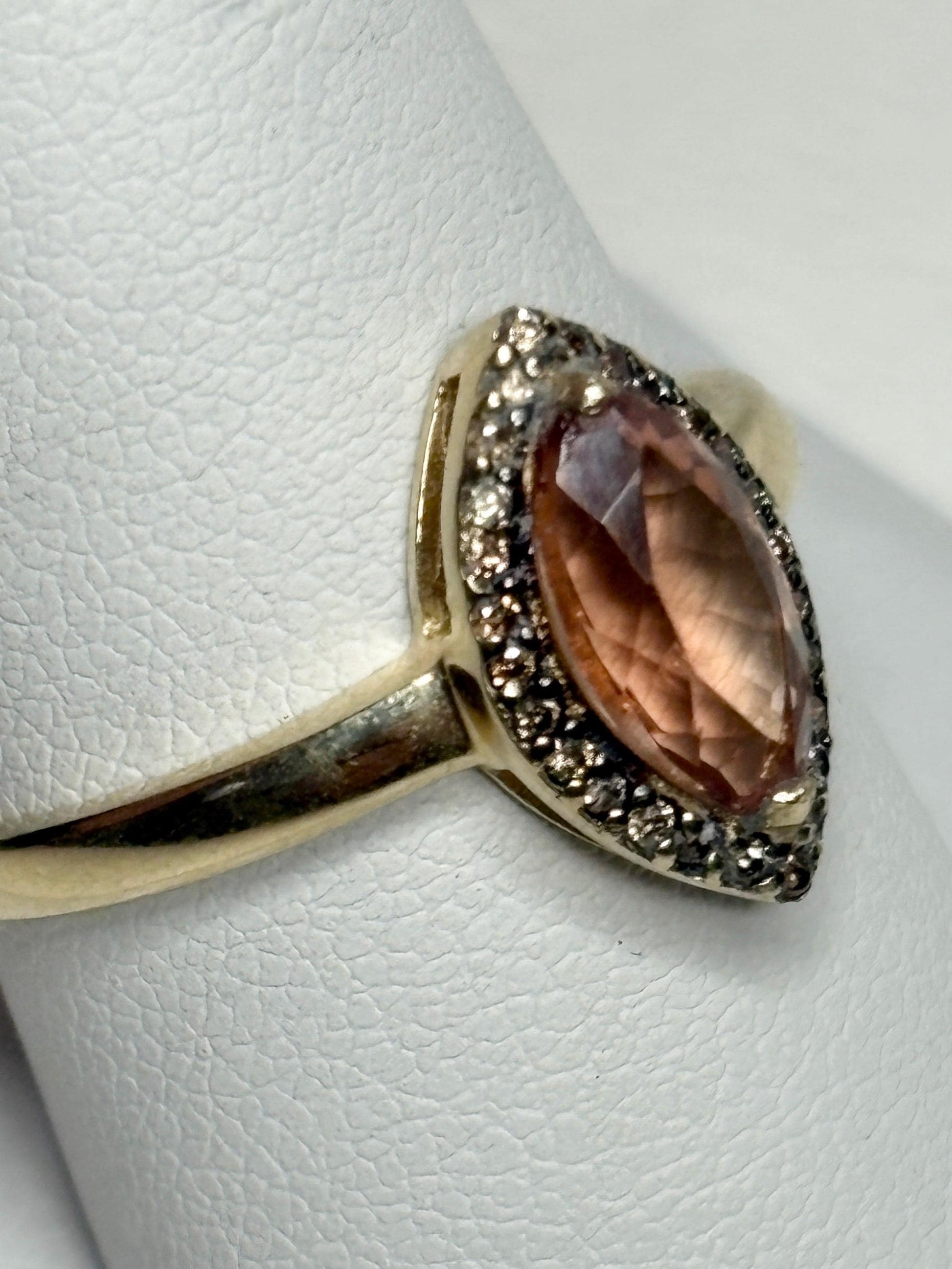 A 10k gold ring with a marquise Oregon sunstone and champagne diamonds.
