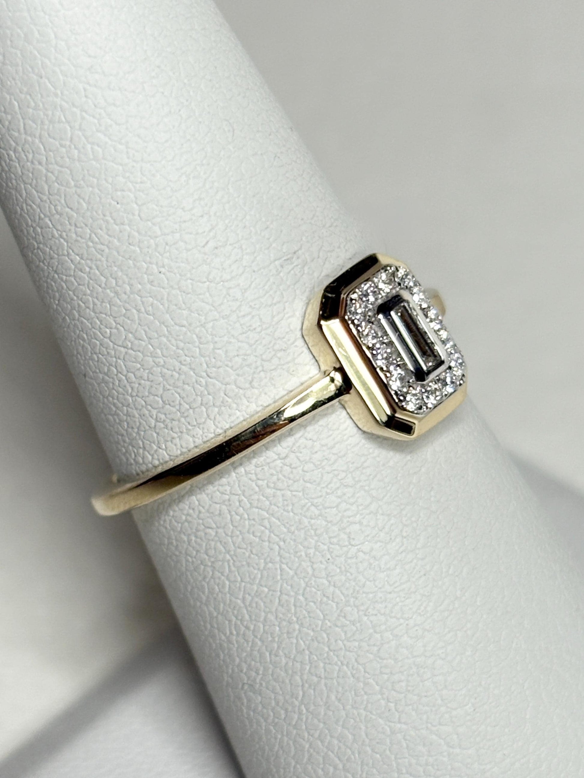 Effy 14k yellow gold ring with a baguette diamond surrounded by smaller diamonds.