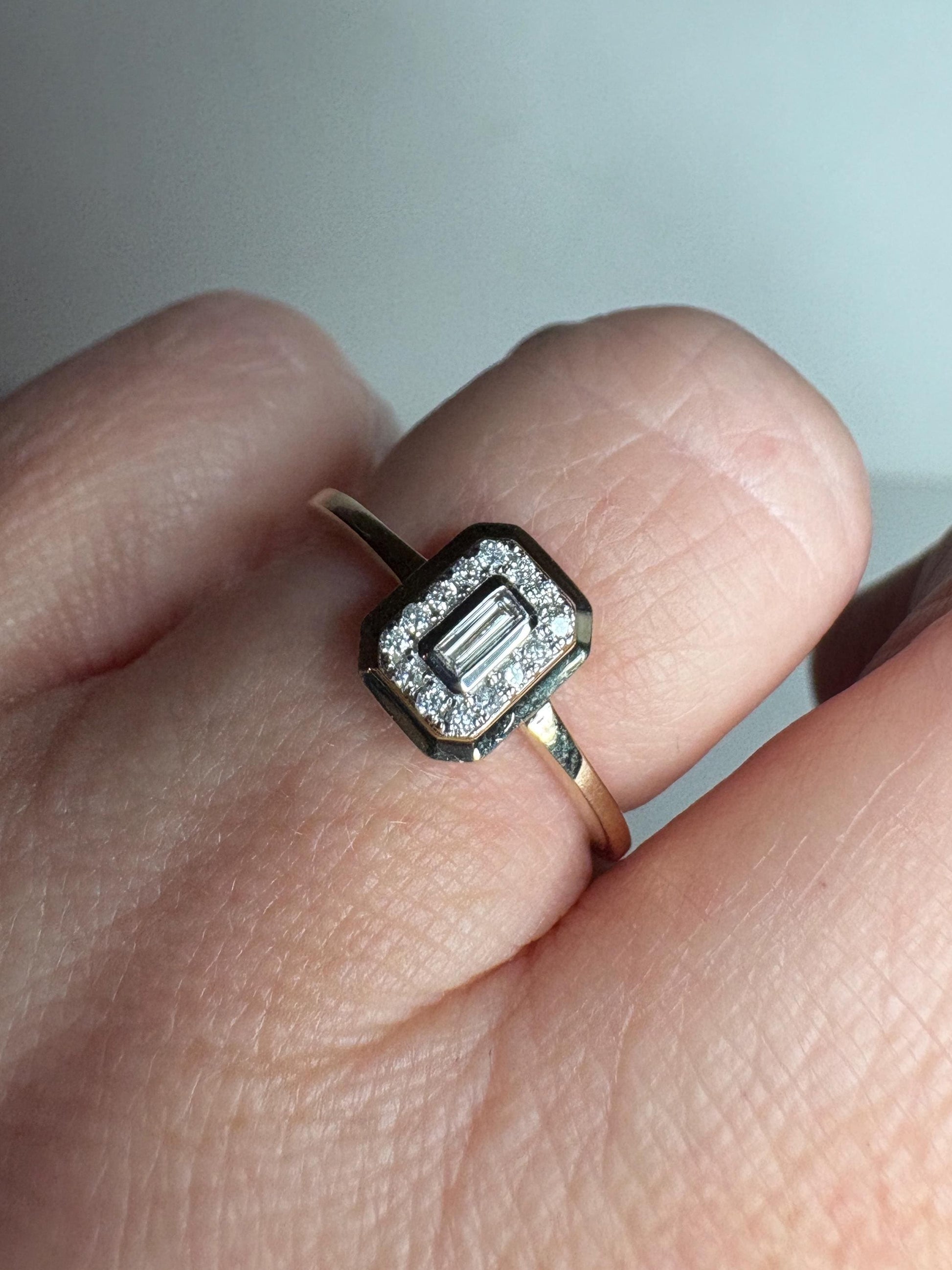 Effy 14k gold ring with a bezel-set baguette diamond surrounded by smaller diamonds.