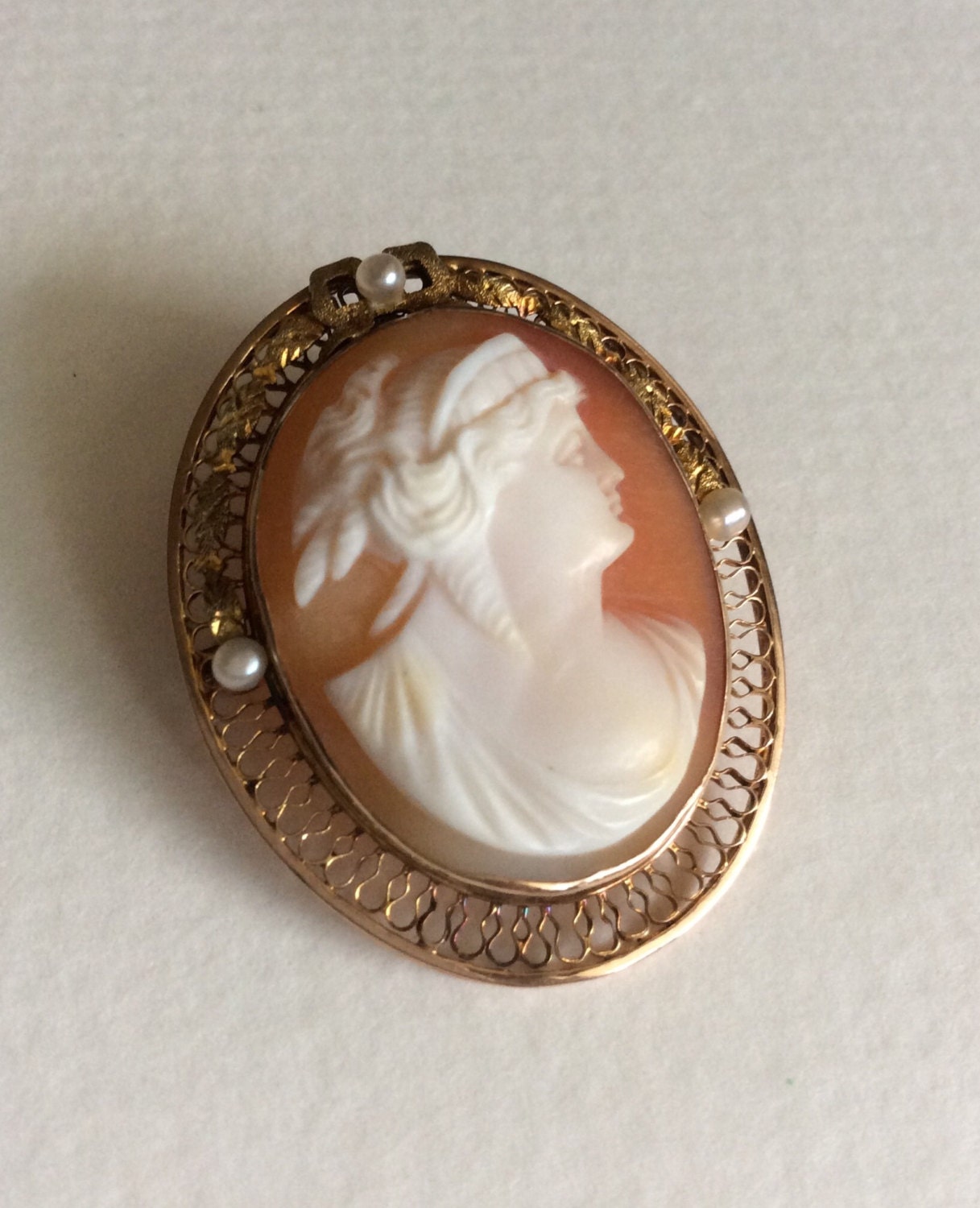 Victorian 10k gold cameo brooch pendant with shell carving and seed pearls.